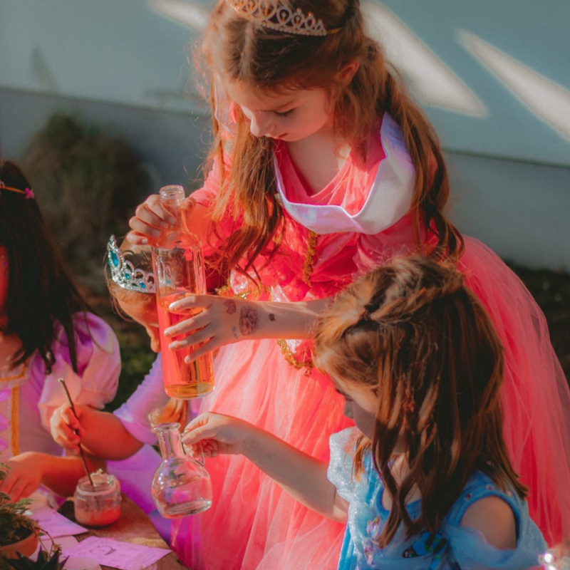 Children creating magical ocean potions with sensory ingredients during an under-the-sea birthday party activity