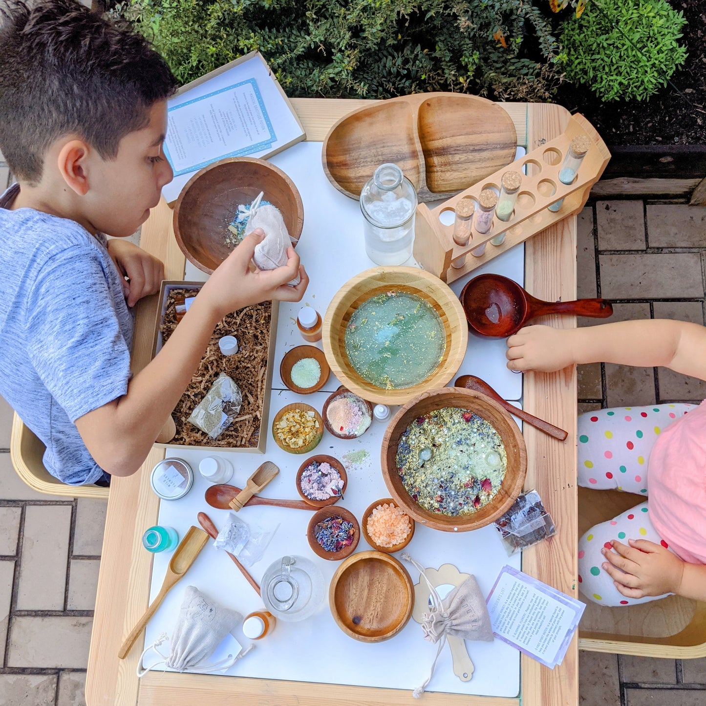 Children creating magical rainbow potions using the Rainbow Joy Potion Kit during hands-on sensory play.